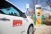 An OPPD electric car next to a charging station
