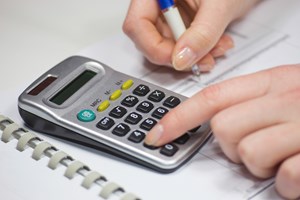 Hand using calculator image